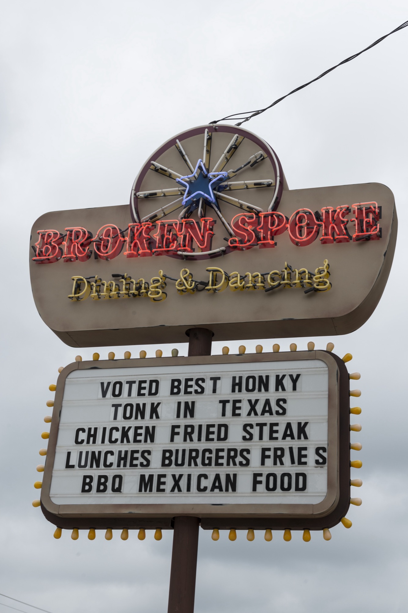 The Broken Spoke's roadside sign: voted best honky tonk in Texas, chicken fried steak