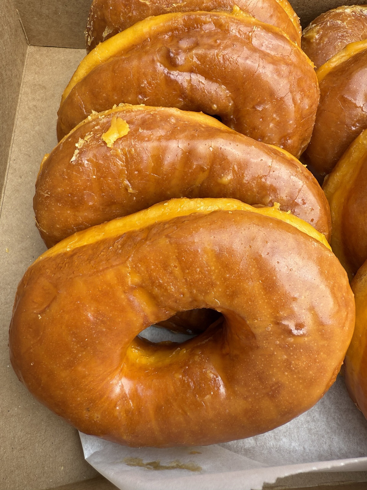 A box of Round Rock's deep-orange glazed donuts